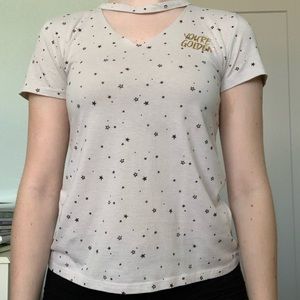 Cream/tan colored t-shirt with a triangle cut out
